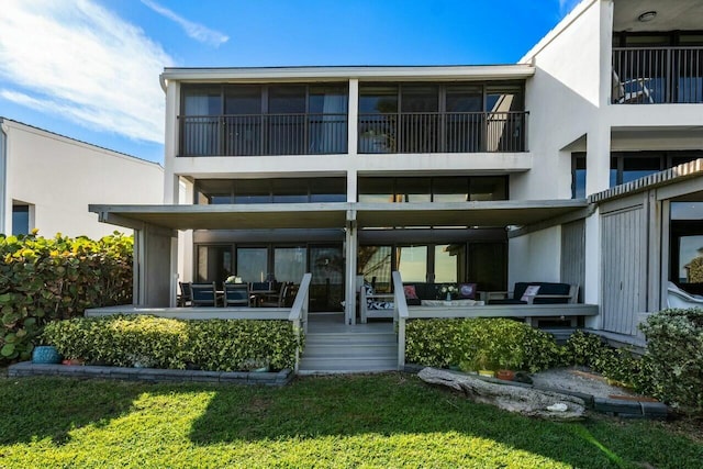 rear view of house with a patio area and a lawn