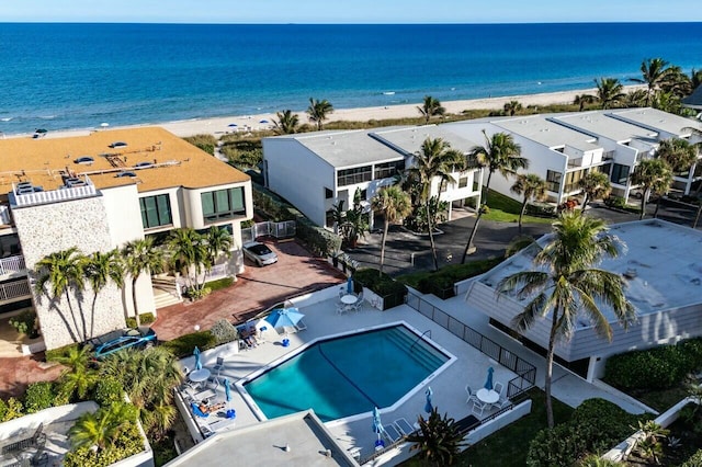 drone / aerial view with a water view and a beach view