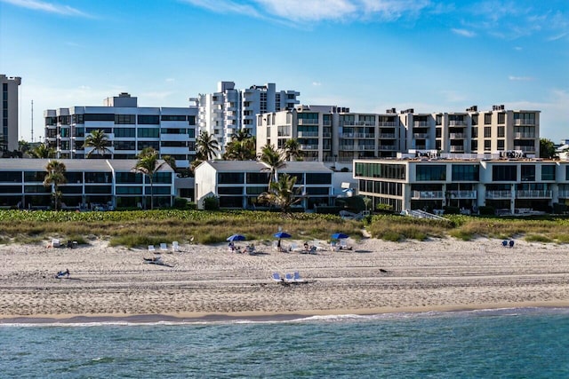 birds eye view of property with a water view and a view of the beach