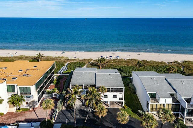 birds eye view of property with a water view and a view of the beach