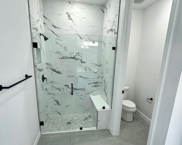 full bathroom with toilet, a marble finish shower, and baseboards