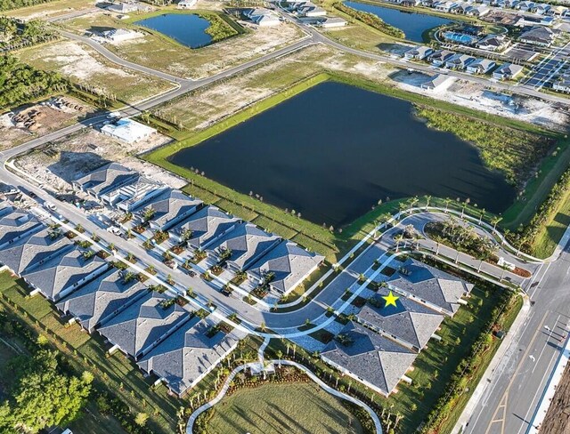 drone / aerial view with a water view and a residential view