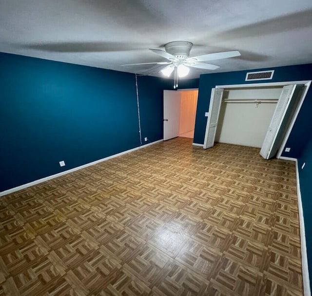 unfurnished bedroom with ceiling fan and light parquet floors