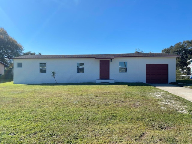 view of front of house with a front yard and a garage