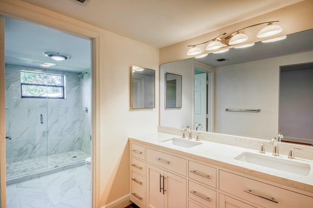 bathroom featuring vanity, toilet, and a shower with shower door