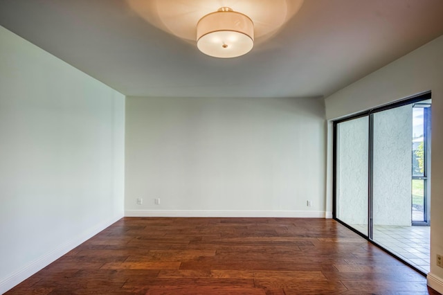 spare room featuring dark wood-type flooring