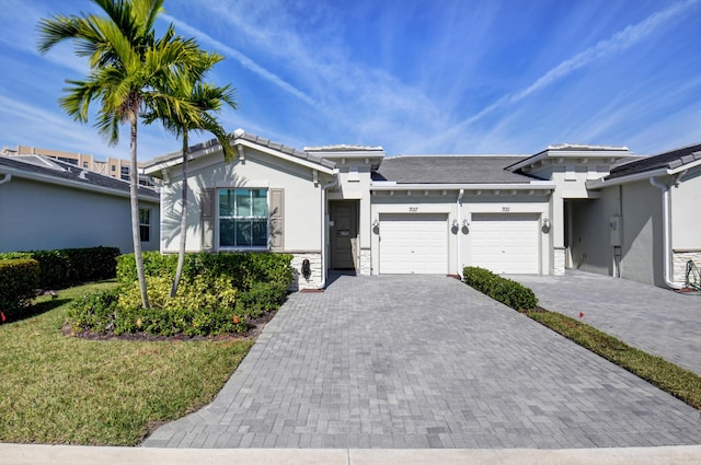 view of front of home featuring a garage and a front yard