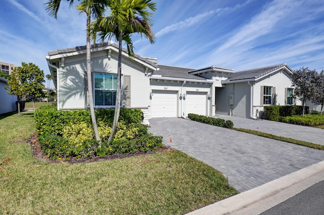 single story home featuring a garage and a front lawn