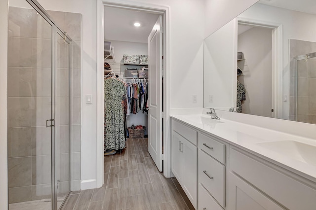 bathroom with vanity and a shower with shower door