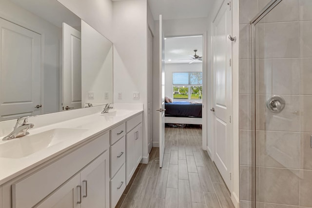 bathroom with ceiling fan, vanity, and an enclosed shower