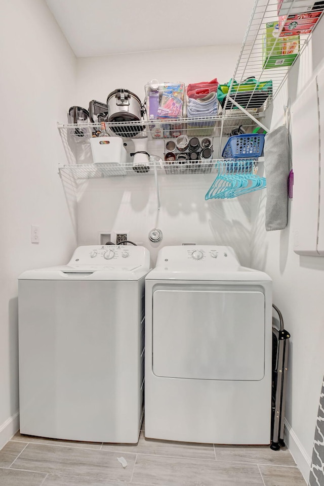 clothes washing area featuring independent washer and dryer