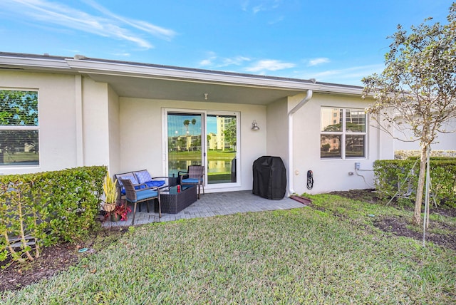 rear view of property with a yard, an outdoor hangout area, and a patio