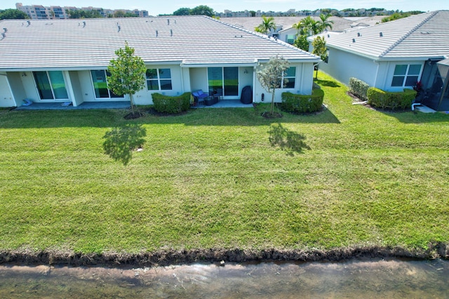 back of property featuring a yard