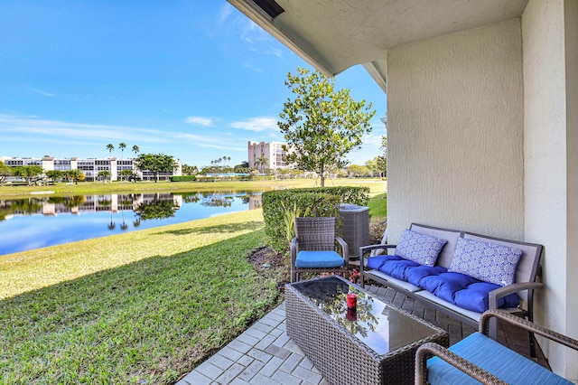 view of patio / terrace with central AC and a water view