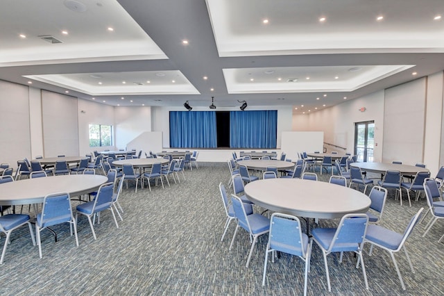 carpeted dining space featuring a tray ceiling