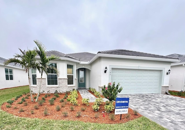 view of front of home featuring a garage and a yard