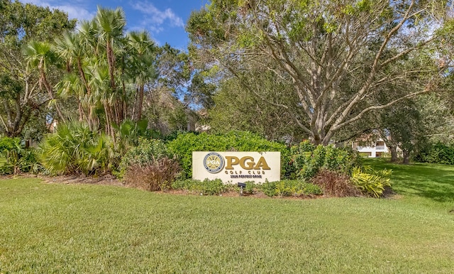 community / neighborhood sign featuring a lawn