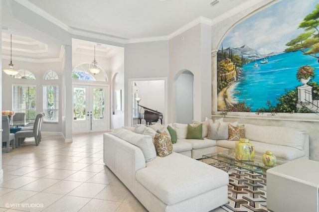 tiled living room with crown molding, french doors, and a high ceiling