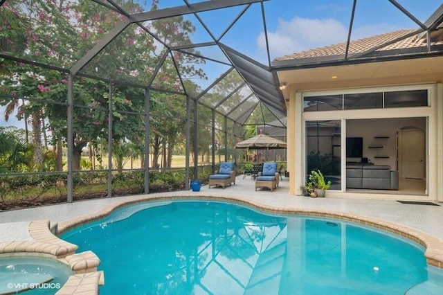 view of swimming pool with a lanai and a patio