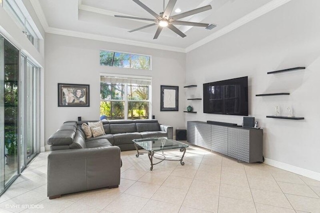 tiled living room with a high ceiling, ornamental molding, and ceiling fan