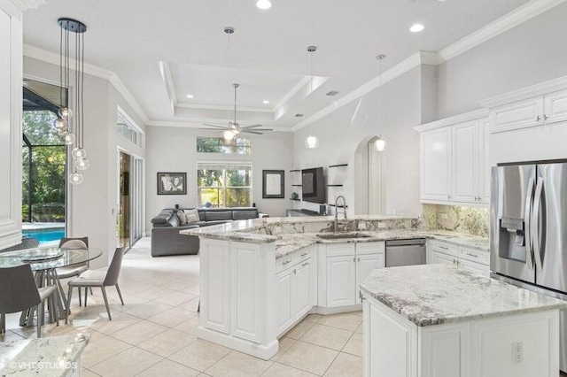 kitchen featuring white cabinetry, appliances with stainless steel finishes, sink, and pendant lighting