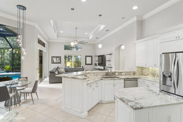 kitchen featuring sink, appliances with stainless steel finishes, hanging light fixtures, ornamental molding, and white cabinets