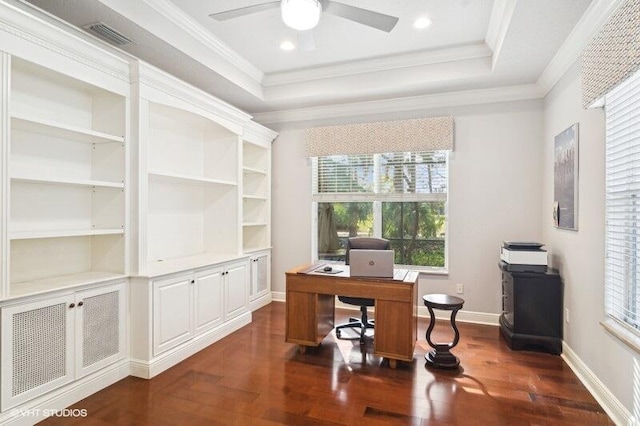 office area featuring dark wood-type flooring, ornamental molding, a raised ceiling, and ceiling fan