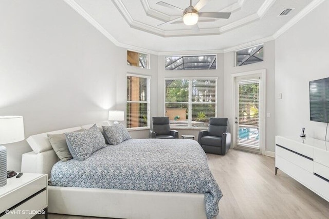 bedroom featuring ceiling fan, access to exterior, hardwood / wood-style floors, a high ceiling, and ornamental molding