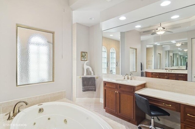 bathroom with vanity, a relaxing tiled tub, and ceiling fan