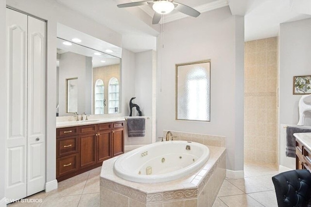 bathroom with tile patterned flooring, vanity, plenty of natural light, and tiled tub