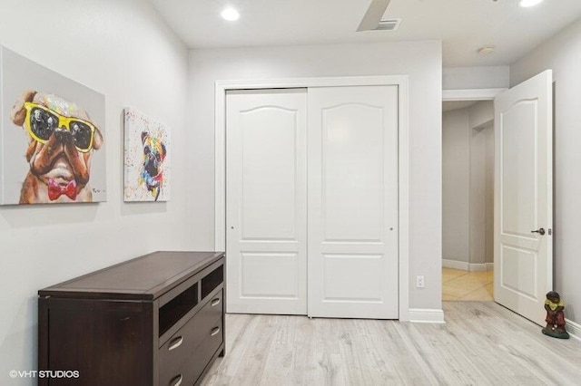 unfurnished bedroom featuring light hardwood / wood-style floors and a closet