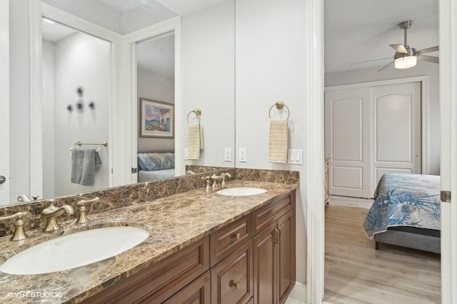 bathroom with ceiling fan, vanity, and hardwood / wood-style floors