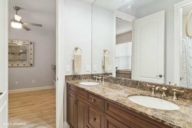 bathroom with vanity, hardwood / wood-style floors, and ceiling fan