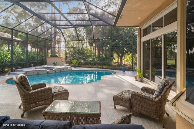 view of pool with an in ground hot tub, a lanai, and a patio