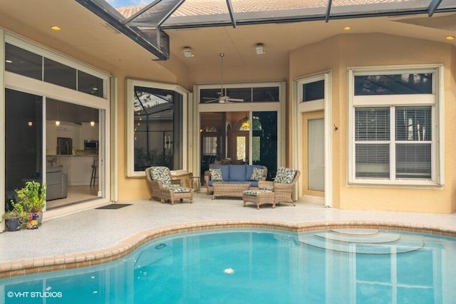 view of pool with a lanai, an outdoor hangout area, ceiling fan, and a patio area