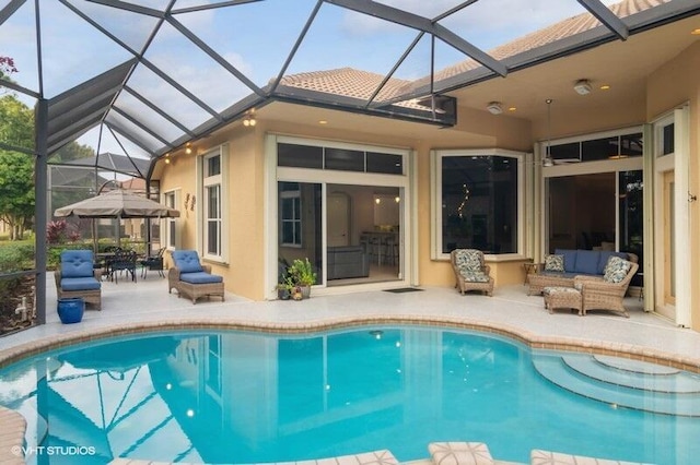 view of swimming pool featuring a lanai, a patio area, and outdoor lounge area