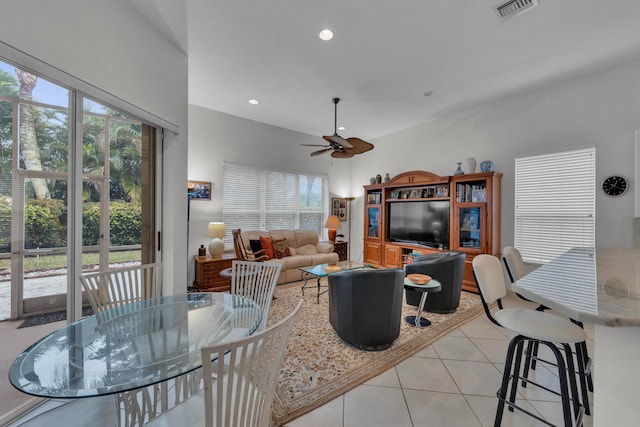 living room featuring light tile patterned floors, plenty of natural light, and ceiling fan