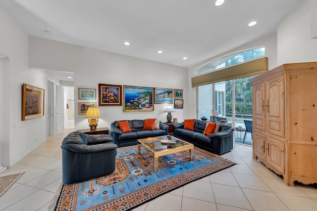 tiled living room featuring a towering ceiling