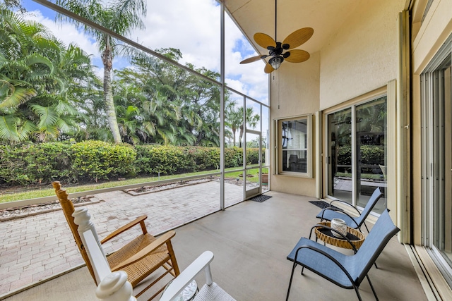 unfurnished sunroom featuring ceiling fan