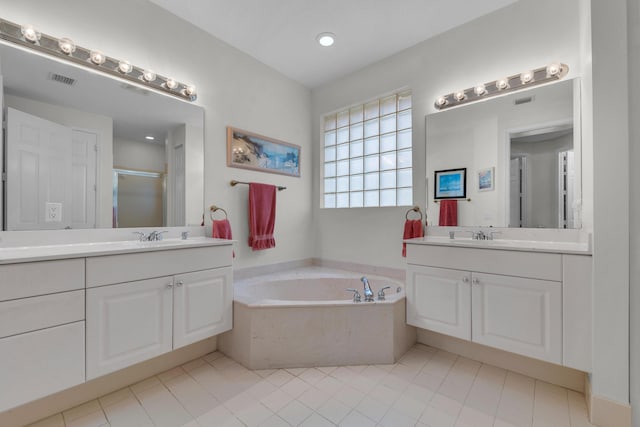 bathroom featuring tile patterned floors, shower with separate bathtub, and vanity