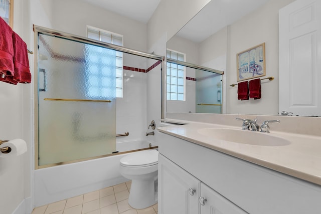 full bathroom with enclosed tub / shower combo, a healthy amount of sunlight, toilet, and vanity