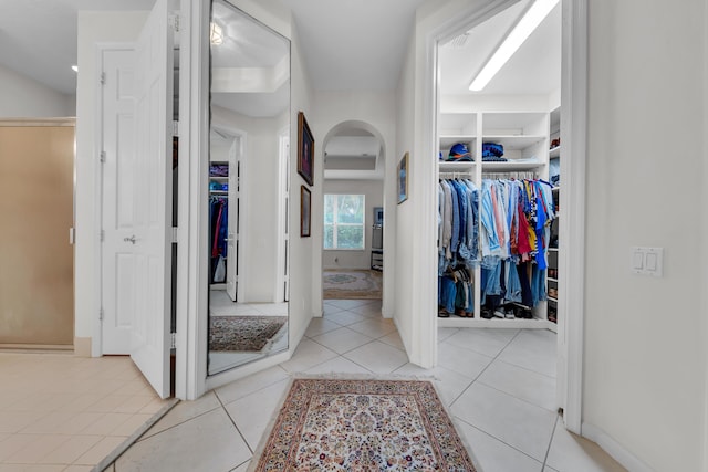 hall with light tile patterned floors