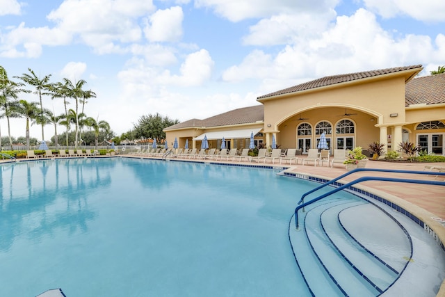 view of pool with a patio and ceiling fan