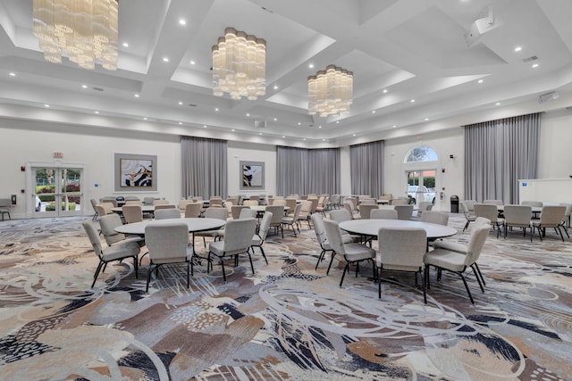 dining area with a towering ceiling and a notable chandelier