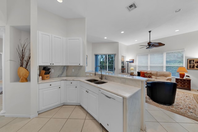 kitchen featuring light tile patterned flooring, dishwasher, sink, white cabinets, and kitchen peninsula