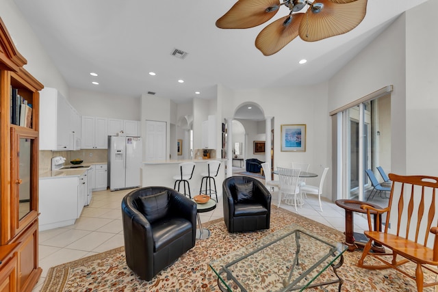 living room with light tile patterned floors and ceiling fan