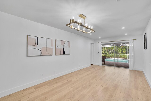 kitchen featuring white cabinets, dishwasher, a kitchen island, sink, and light hardwood / wood-style flooring