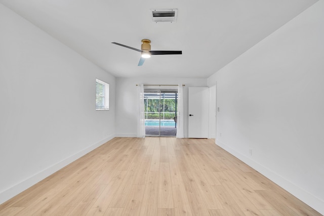 empty room with ceiling fan and light hardwood / wood-style floors