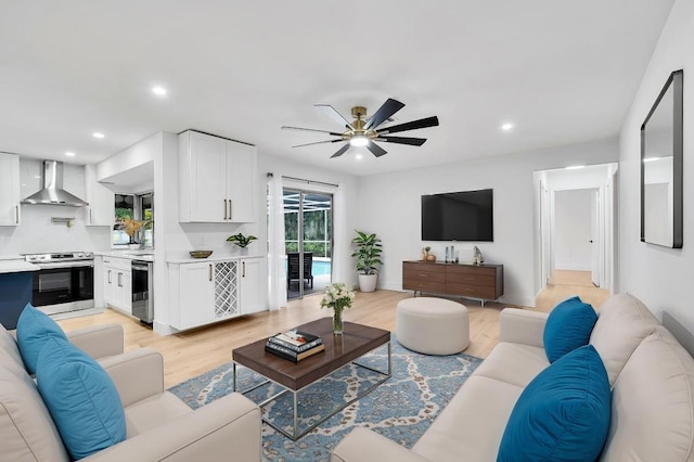 living room featuring ceiling fan and light wood-type flooring