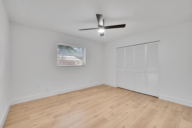 unfurnished bedroom with ceiling fan, a closet, and light wood-type flooring